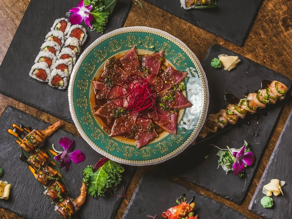 Overhead shot of an elaborate, artfully plated sushi and sashimi spread.