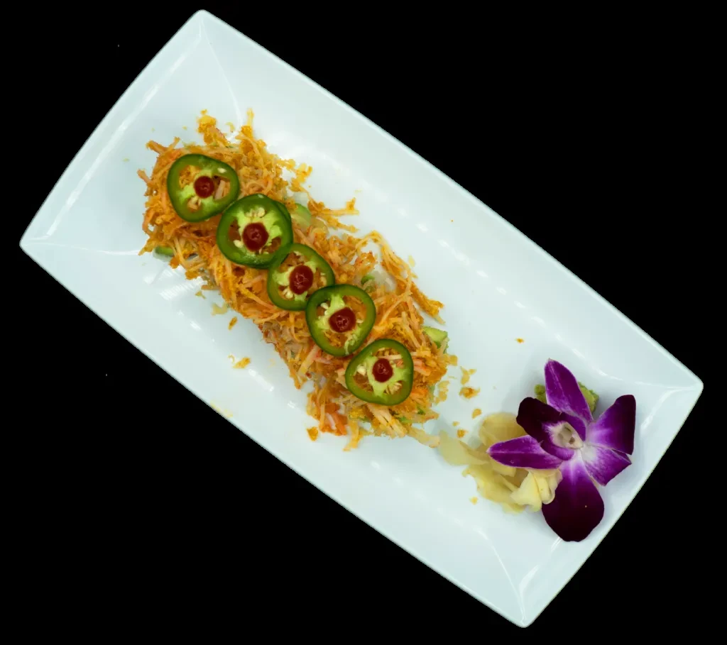 Sushi roll with crispy fried shreds, jalapeños, ginger, and an orchid.