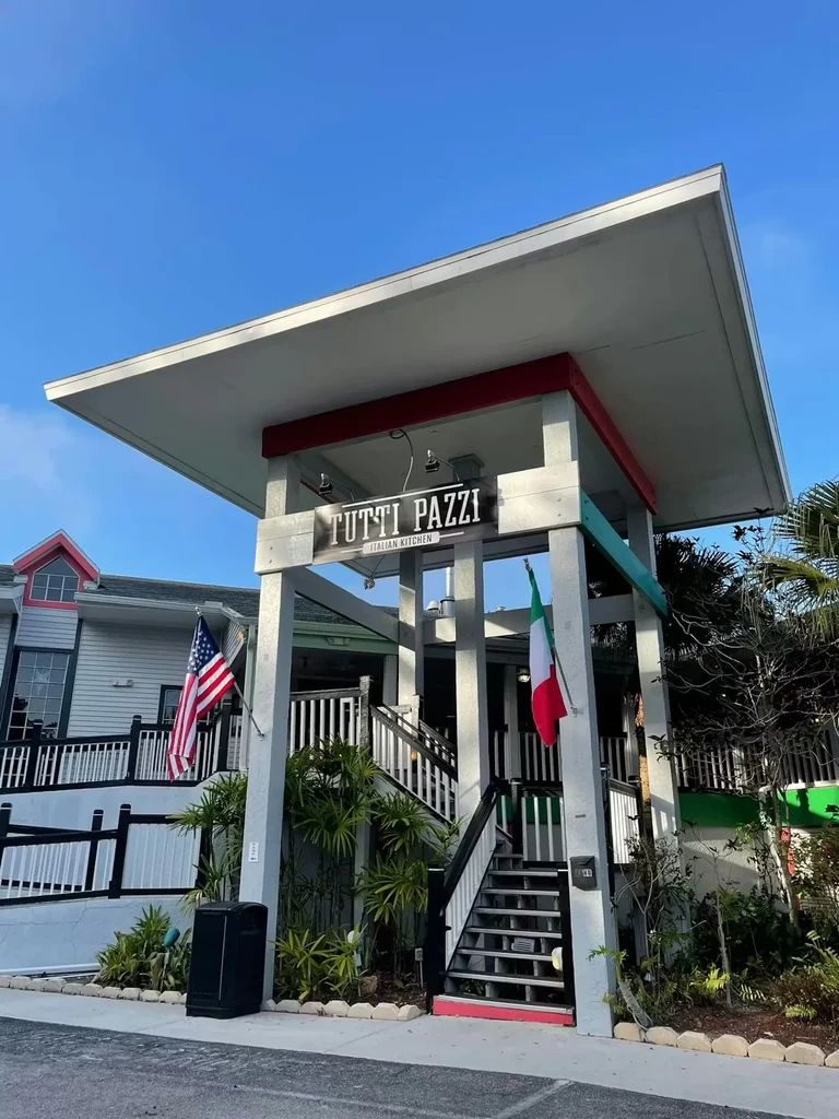 TUTTI PAZZI ITALIAN KITCHEN: Modern entrance, stairs, American and Italian flags.