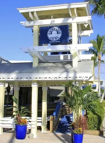 Sunny exterior of Backwater Jacks Resort building with coastal architecture.