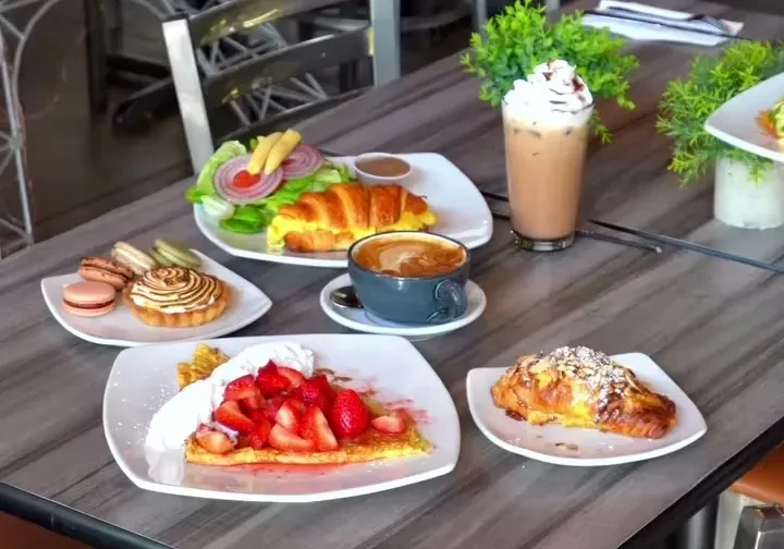 Overhead shot of a diverse brunch spread on a grey marble table.