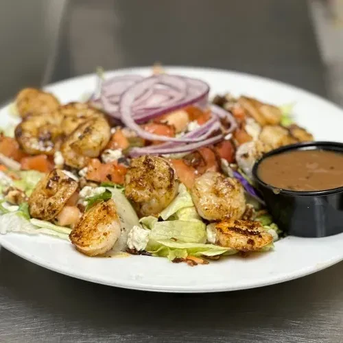 Grilled shrimp or scallop salad with greens, tomatoes, cheese, dressing.