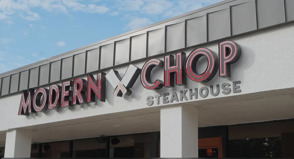 MODERN CHOP STEAKHOUSE sign, Y replaced by crossed meat cleavers.