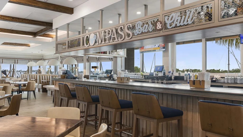 COMPASS Bar & Chill interior: modern bar, dining area, and waterfront view.