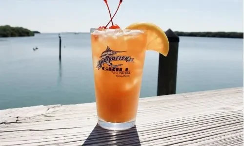 Orange drink with cherries, lemon, Swordfish Grill Cortez, Florida, on pier.