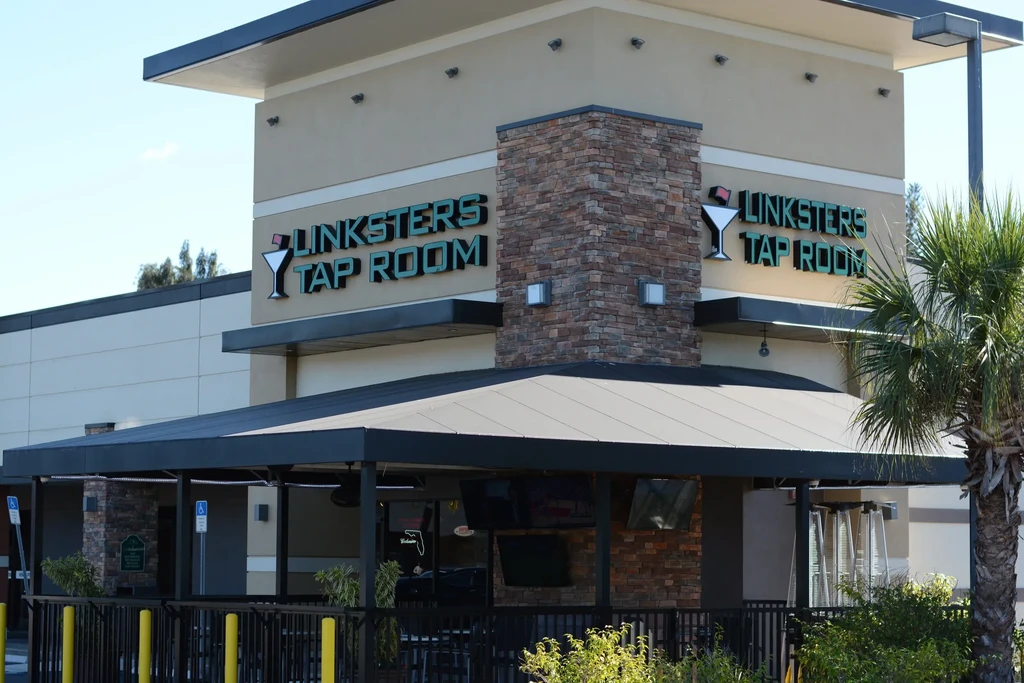 Linksters Tap Room's exterior with stone pillar and covered patio.