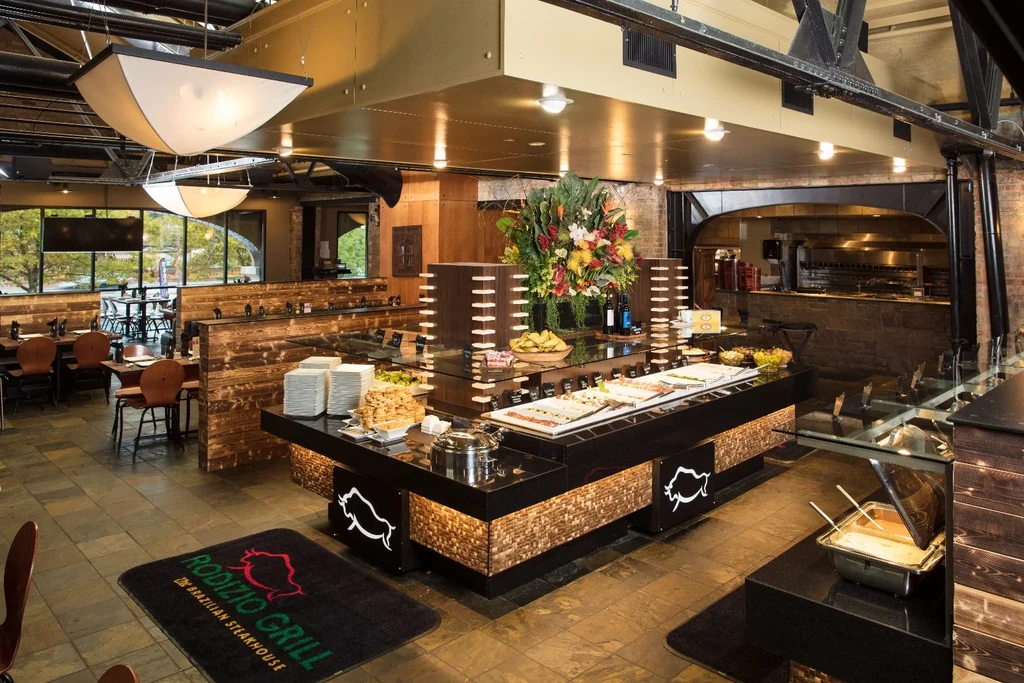 Rodizio Grill Brazilian steakhouse interior with a large central buffet.
