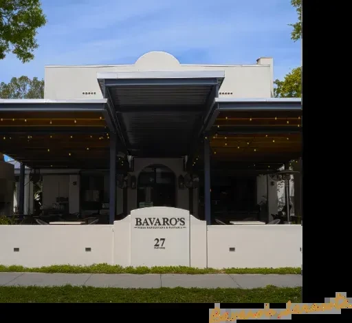 Bavaro's Pizza restaurant exterior with arched entrance and covered patios.