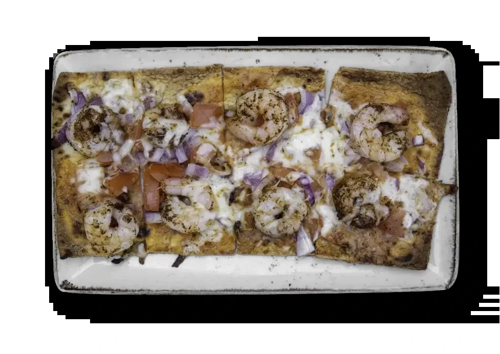 Shrimp flatbread with melted cheese, diced vegetables, and herbs on a plate.