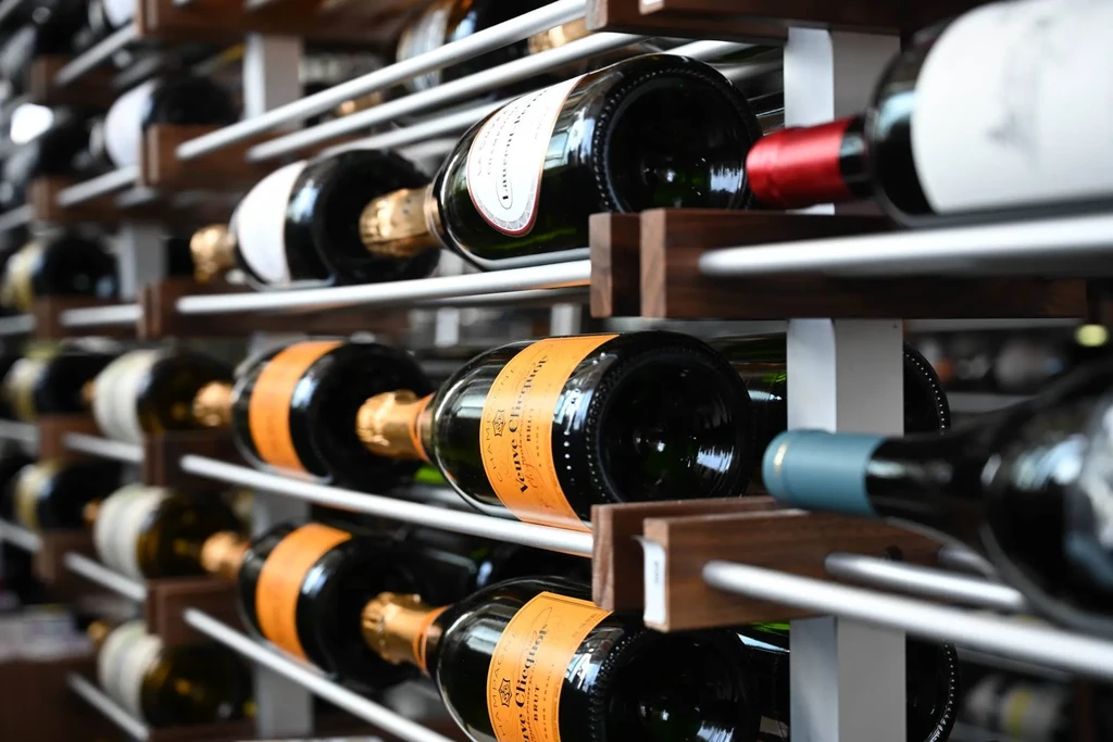 Close-up of a wine rack with Veuve Clicquot and other wine bottles.