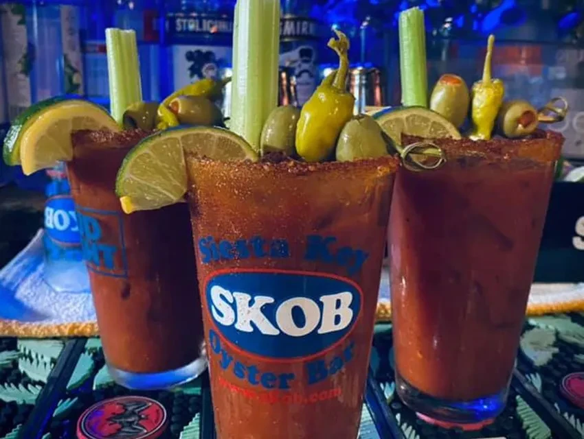 Three Bloody Mary cocktails with garnishes at Siesta Key SKOB Oyster Bar.