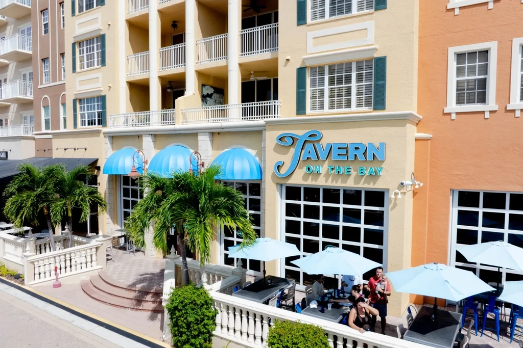 Diners enjoy the sunny outdoor patio of TAVERN ON THE BAY restaurant.