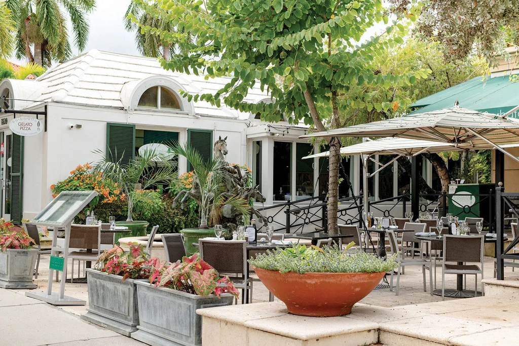 Barbatella Gelato Pizza restaurant exterior with outdoor dining and horse sculpture.