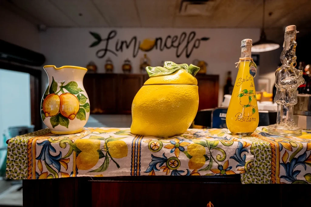 Lemon-themed still life with limoncello bottle and Limoncello wall text.
