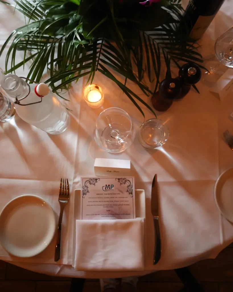 Elegant top-down view of a warm-lit dining table place setting.