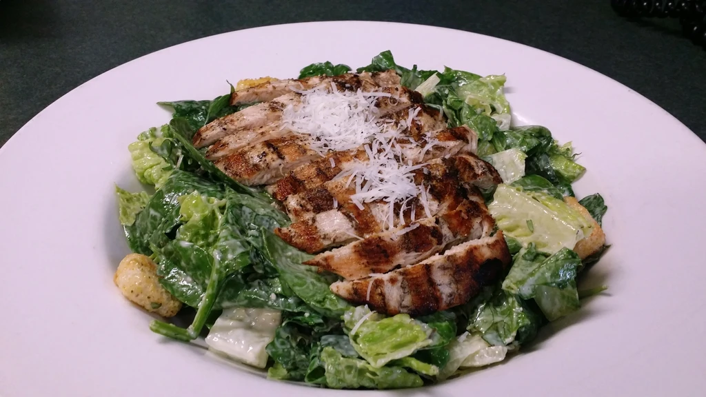 Grilled chicken Caesar salad with romaine, croutons, and Parmesan.