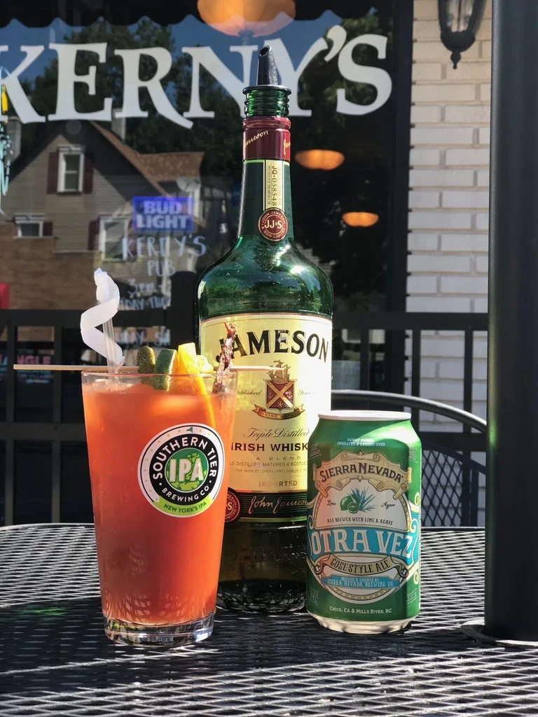 Cocktail, Jameson whiskey, and Sierra Nevada ale on a patio table.