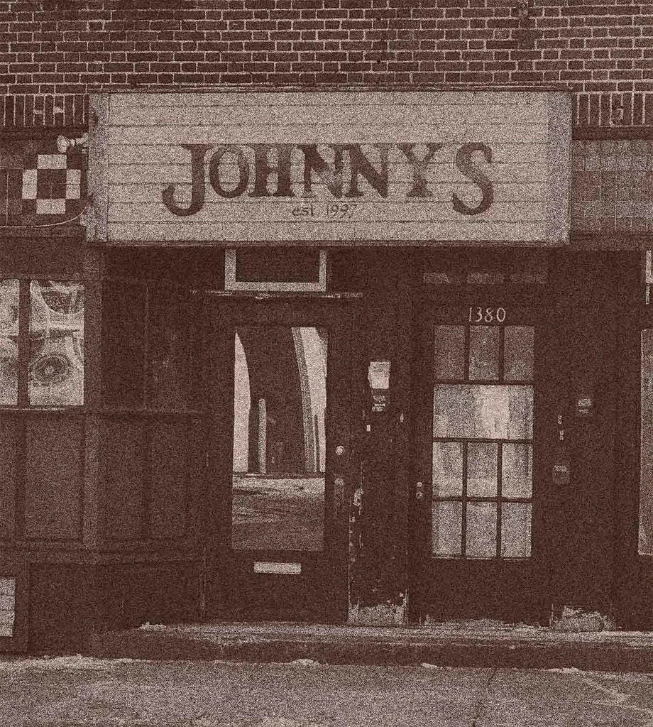Sepia photo of Johnny's "est. 1997" building (1380) with snow.