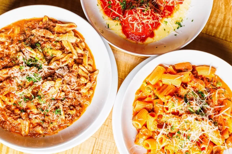 Three pasta dishes: meat sauce, meatballs, and rigatoni.