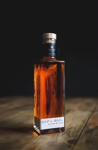 Hollerhorn Malt in Motion Rye Single Malt whiskey bottle on wood.