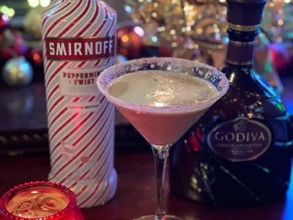 Creamy martini, Smirnoff Peppermint Twist vodka, Godiva liqueur, festive lights.