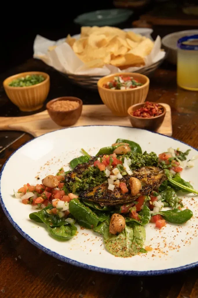 Grilled portobello mushroom with pesto, tomatoes, and spinach.