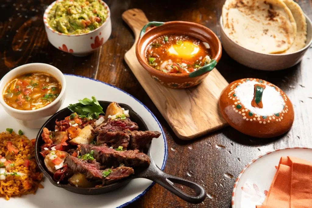 Mexican or Tex-Mex dishes on a rustic wooden table.