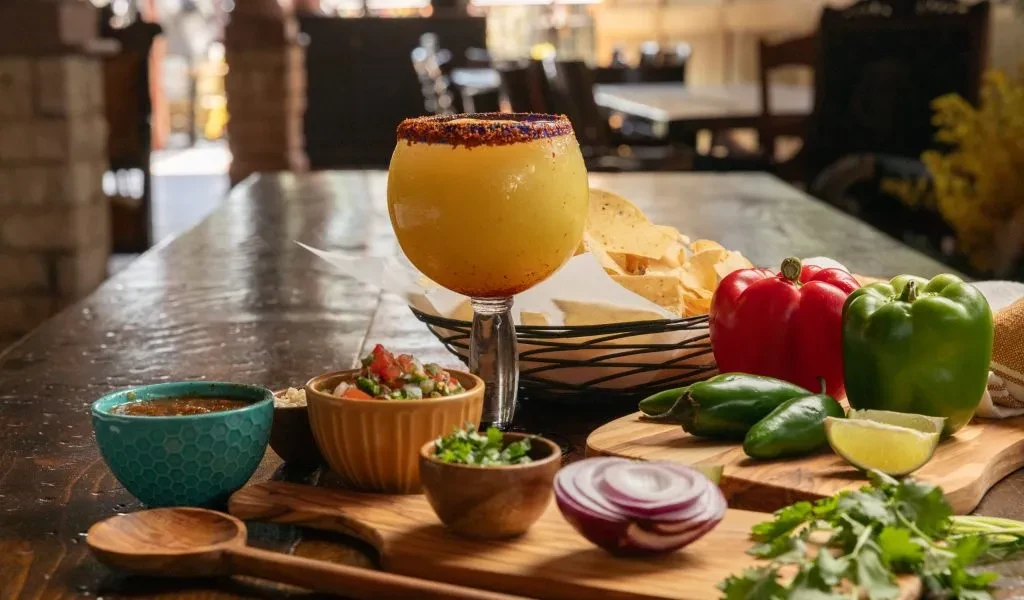 Close-up of Mexican food, including a frozen drink and ingredients.
