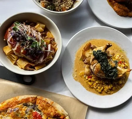 Overhead view of a table with multiple beautifully presented dishes.