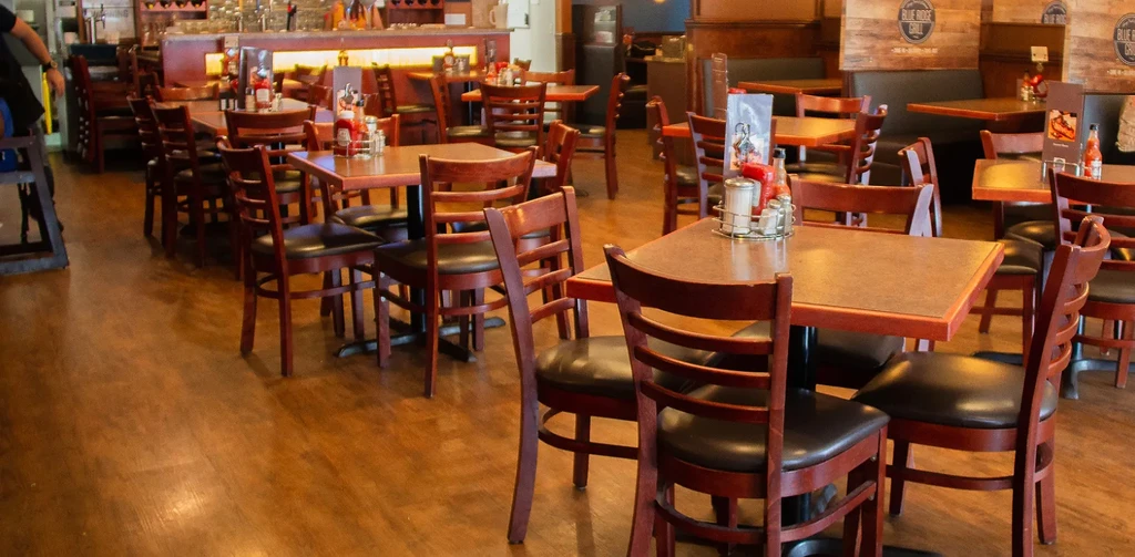 Empty Blue Ridge Grill dining area with tables, chairs, and bar.