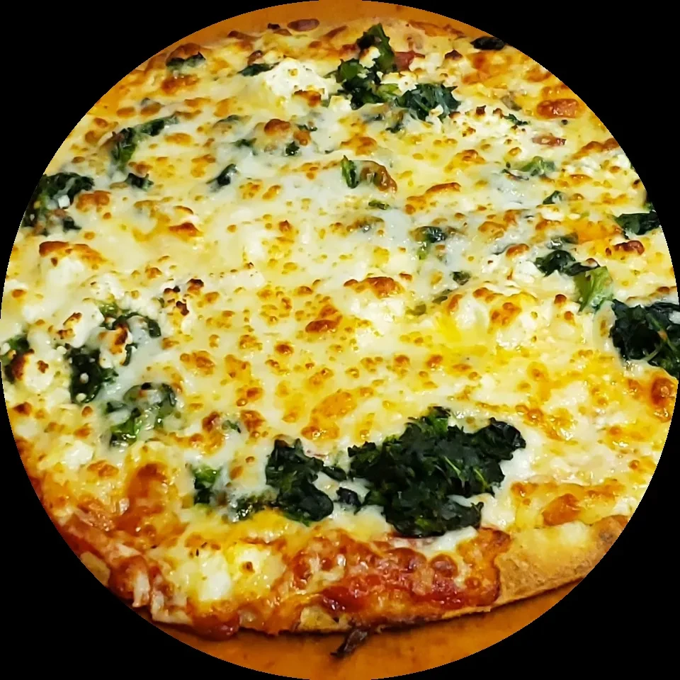 Round white pizza with mozzarella, ricotta, and spinach from above.