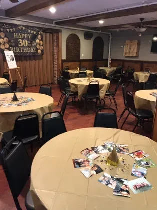 Decorated restaurant event space set for a 30th birthday party.