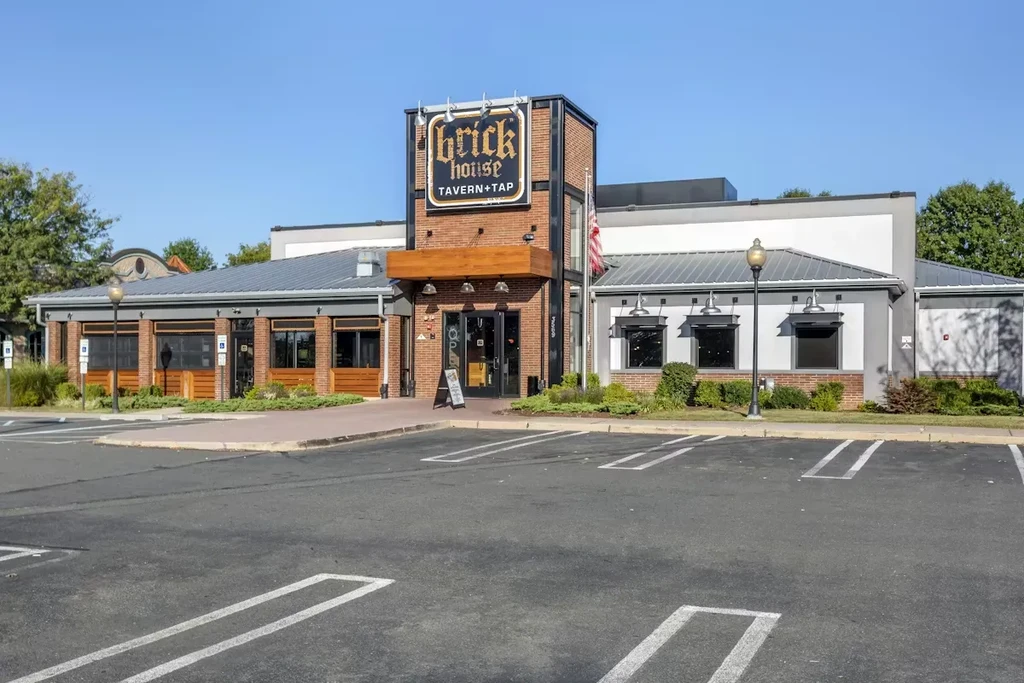 Exterior of Brick House Tavern + Tap, a brick building with parking.