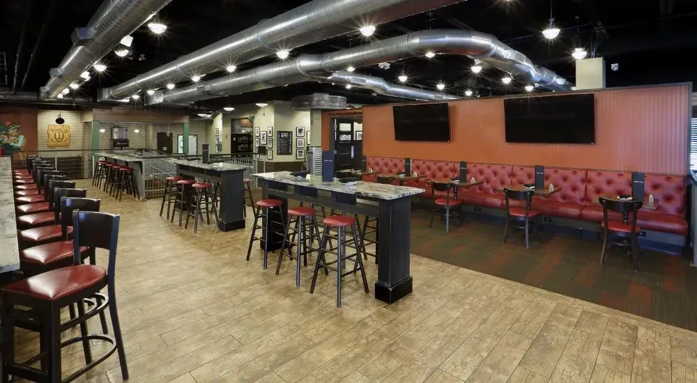 Spacious, modern restaurant interior with diverse seating and industrial-chic design.