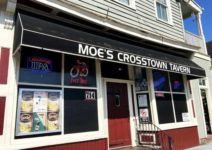 Moe's Crosstown Tavern facade with red lower level and beer signs.