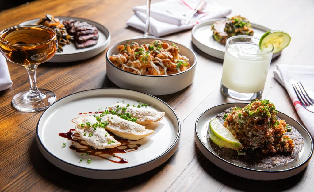 A diverse spread of beautifully presented food and drinks on a table.