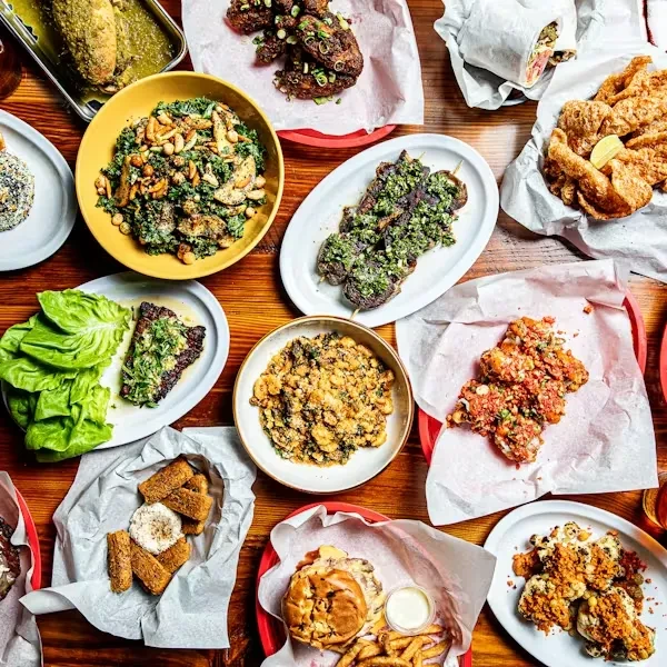 Overhead shot: A wooden table laden with various prepared food dishes.