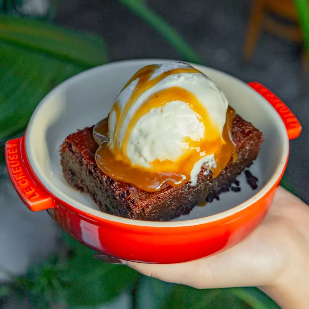 Brownie, vanilla ice cream, caramel in a red Le Creuset ramekin.