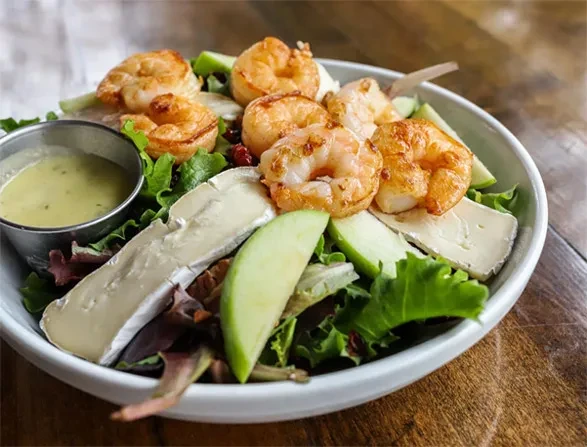 Fresh salad with shrimp, brie cheese, green apple, and mixed greens.
