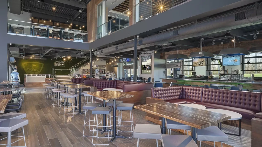 Spacious, modern Topgolf multi-level restaurant and bar with varied seating.