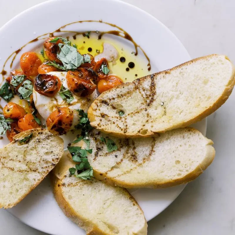 Fresh mozzarella, roasted tomatoes, basil, baguette, drizzled with oil.