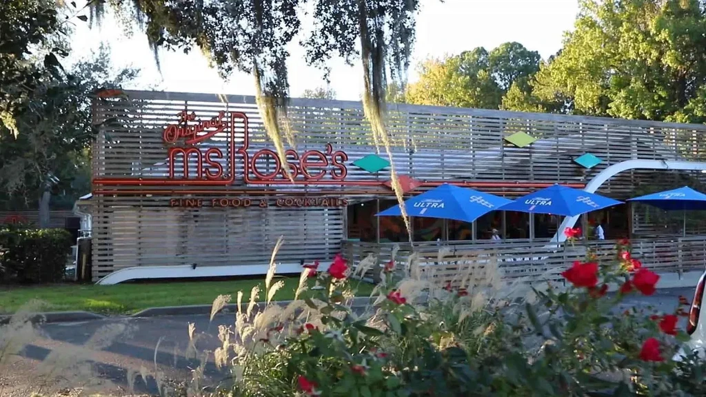 Exterior of Ms. Rose's restaurant with red sign and outdoor patio.