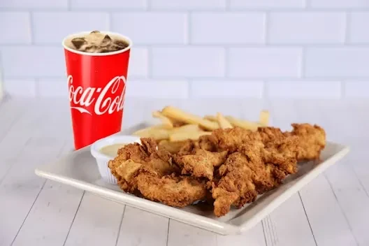 Crispy chicken tenders, french fries, dipping sauce, and a Coke.