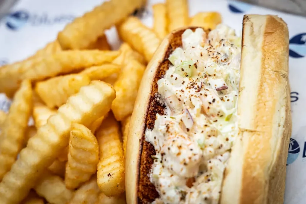 Toasted seafood roll with creamy filling and golden crinkle-cut fries.