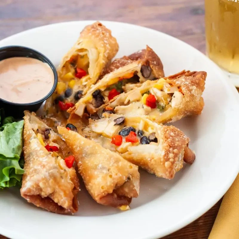 Crispy fried appetizers with chicken, bean, corn, pepper filling and sauce.