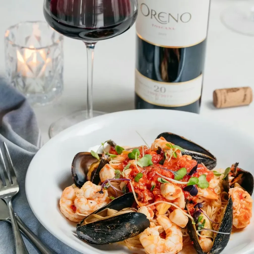Seafood pasta with shrimp, mussels, tomato sauce, and wine.