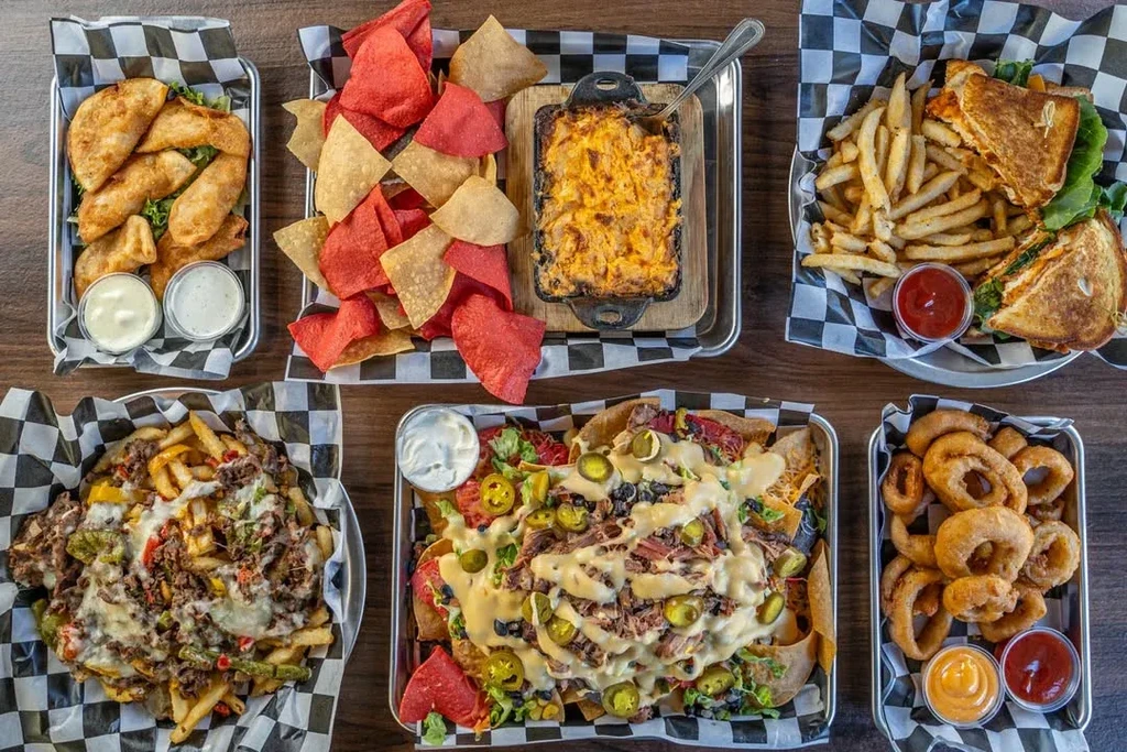 Overhead shot of comfort food appetizers and meals on a table.