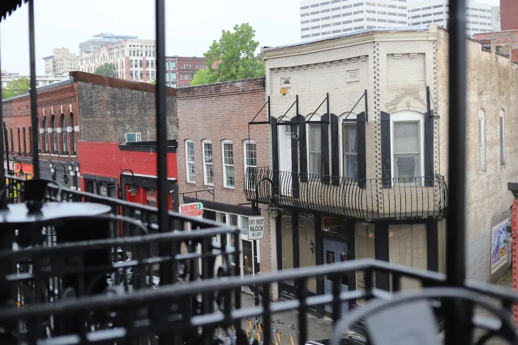 Elevated view of a street with historic buildings and modern city.