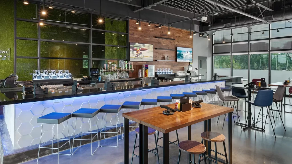 Empty modern bar interior with blue LED bar and living wall.