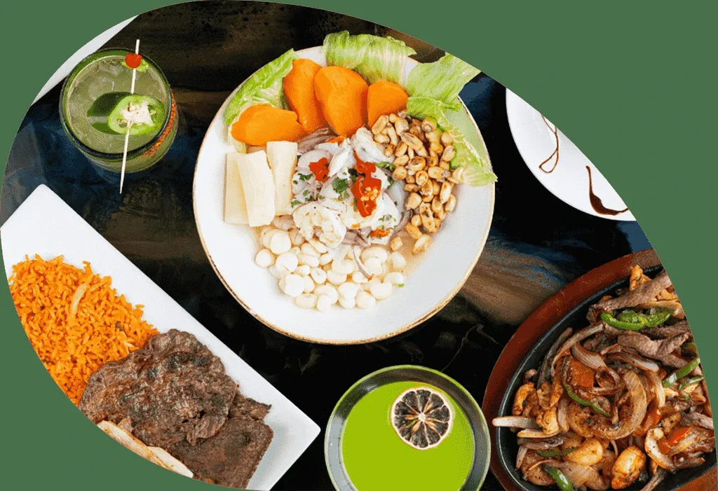 Vibrant overhead shot of ceviche, meat, rice, and drinks on a table.